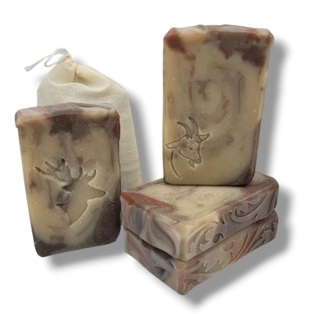 Handmade Ironwood Reserve goat milk soap bar with sandalwood musk scent, shown in muslin sack with rustic deer-themed label