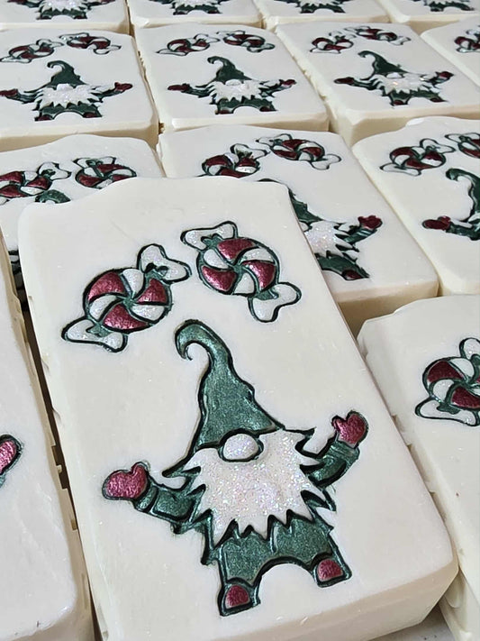 Hand-painted goat milk soap bar with elf candy design, wrapped for holiday gifting in cucumber melon scent