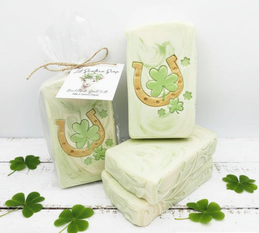 Green soap bars with horseshoe and clover design on a white background