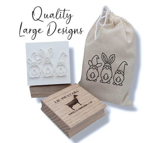 Three Gnomes soap stamp with recessed spring gnome trio design on red oak wood base, 57×43 mm.