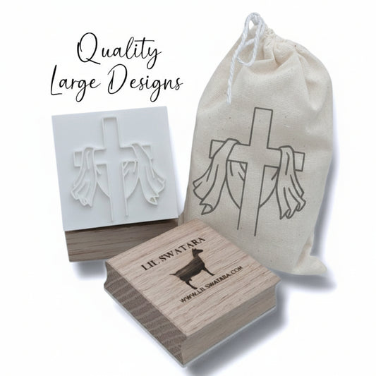 Risen cross soap stamp with draped cloth design on red oak wood base, 57×52 mm.