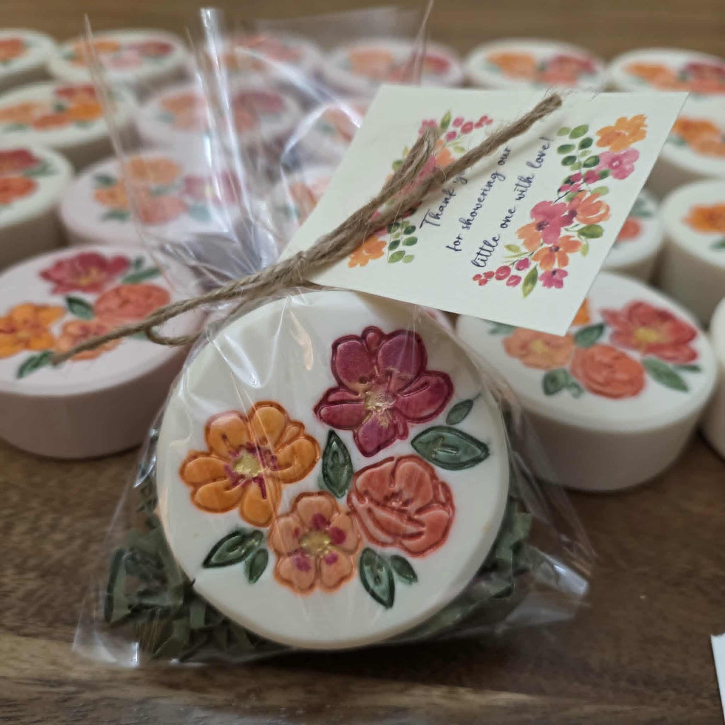 A finished, stamped, and mica-painted floral soap bar gift-wrapped with a thank-you tag, ready for presentation.