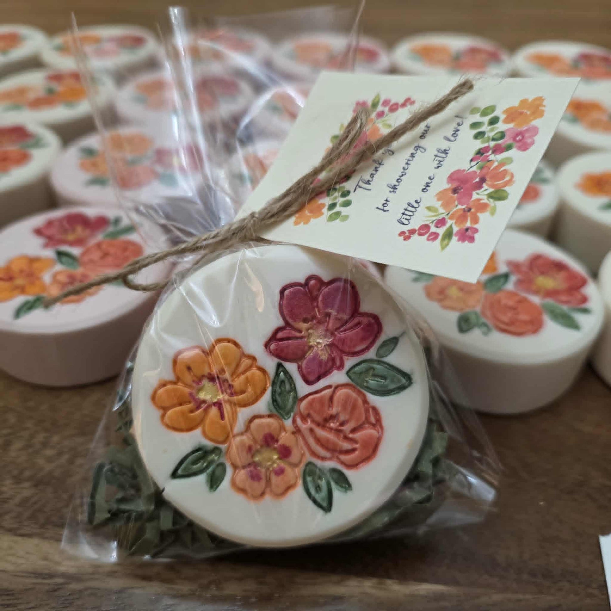 A finished, stamped, and mica-painted floral soap bar gift-wrapped with a thank-you tag, ready for presentation.