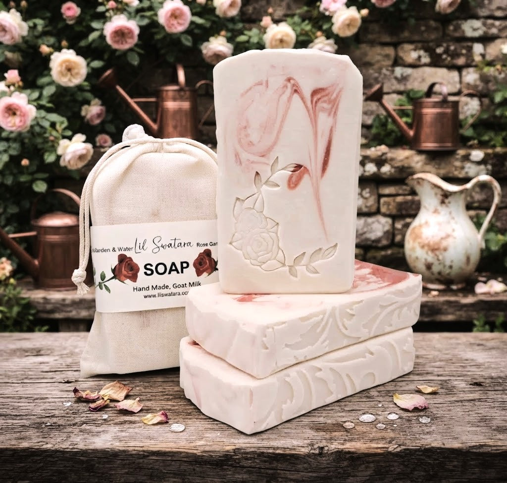 Rose Garden & Water goat milk soap bar with creamy rose swirls, floral embossing, and muslin bag in a soft garden setting.
