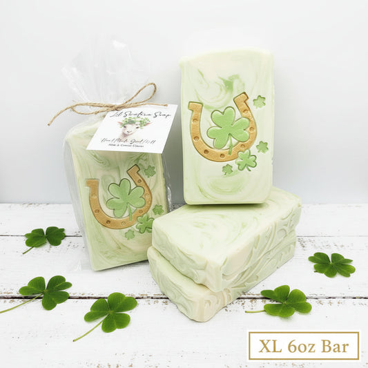 Handmade Aloe Clover goat milk soap bars with golden horseshoe and clover designs, wrapped for gifting