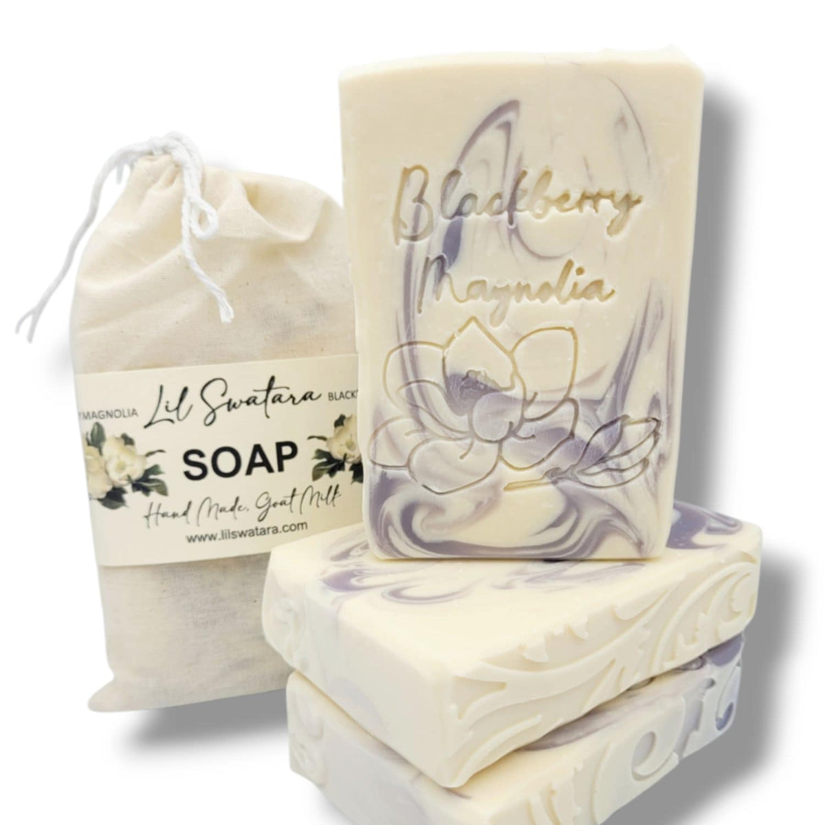 Three bars of Blackberry Magnolia soap with a drawstring bag on a white background