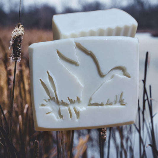Duck Fly wildlife soap stamp for handmade soaps, shown with rustic wood handle and crisp bird impression design