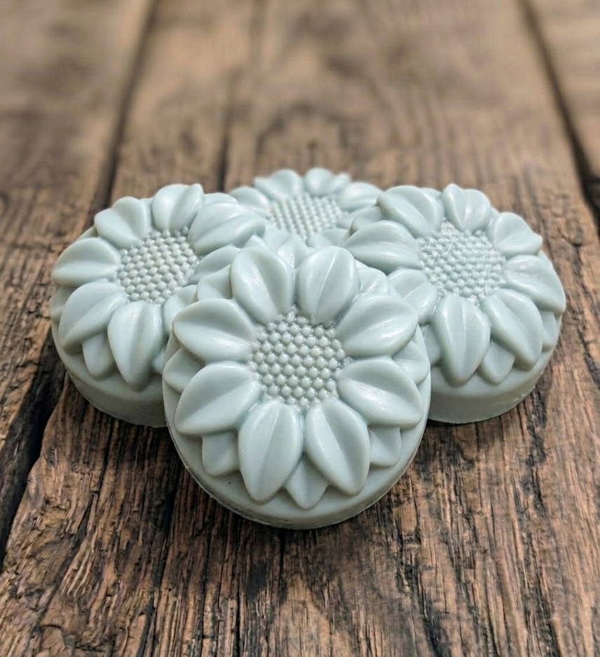 Handcrafted goat milk tallow shampoo flower bar with detailed petals and creamy lather.