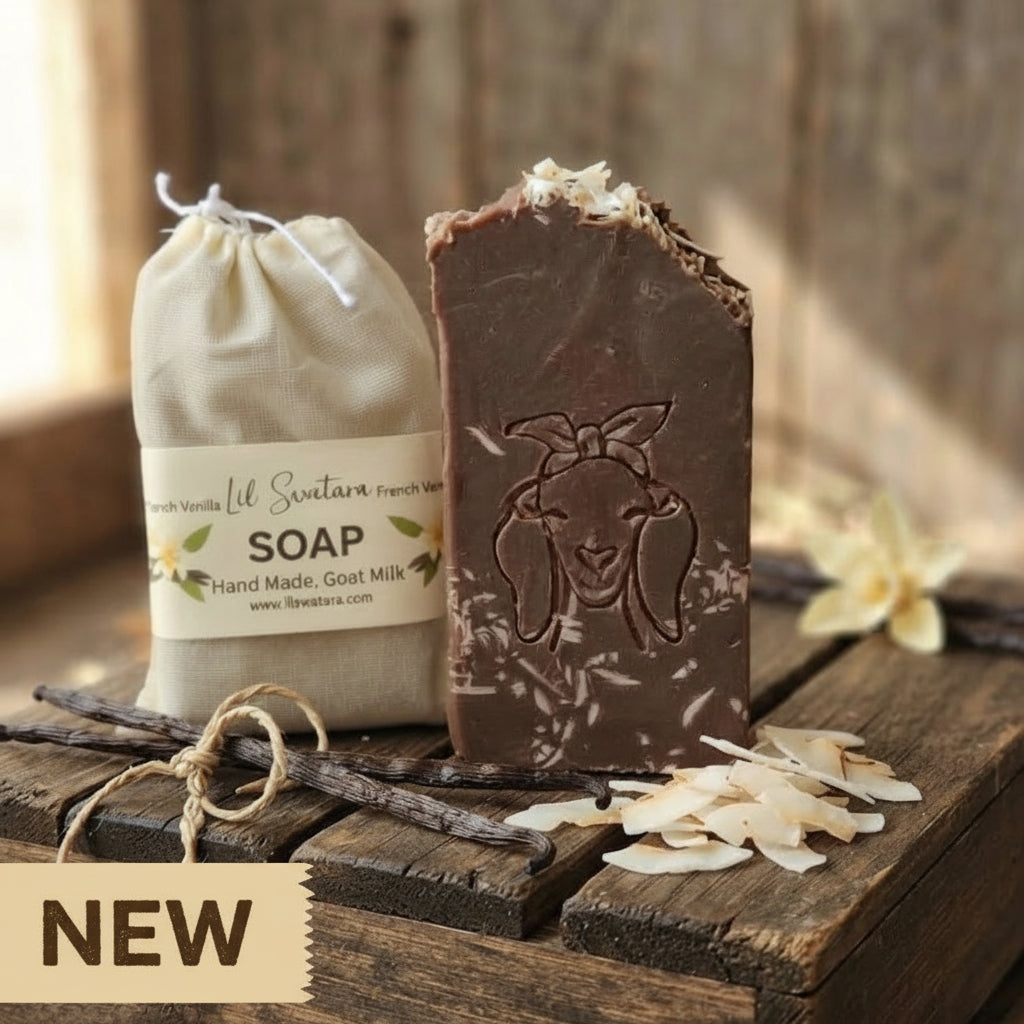 French Vanilla goat milk tallow soap XL 6oz bar with deep vanilla bean color, rustic shaved vanilla topping, and goat head stamp displayed on barnwood beside muslin packaging.
