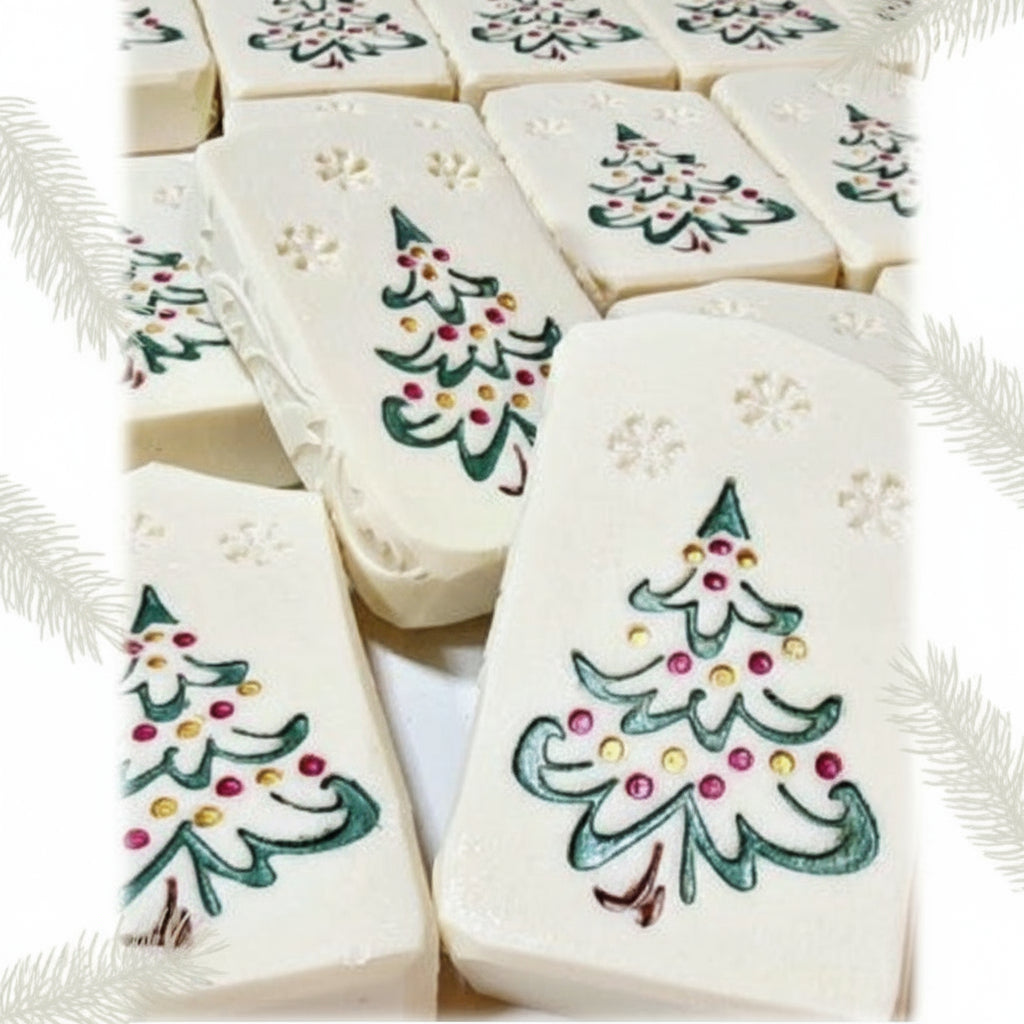 Hand-painted goat milk soap bar with festive Christmas tree design, wrapped in clear packaging with goat tag for holiday gifting