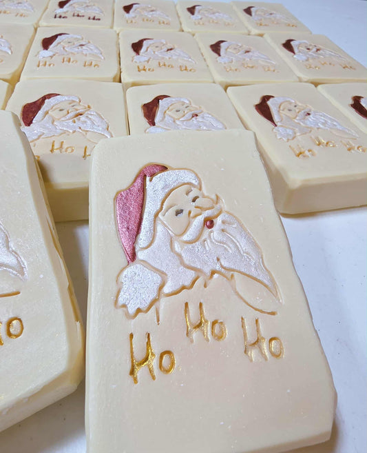 Three bars of soap with Santa Claus design and 'Ho Ho Ho' great for gifting.