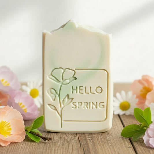 Handmade soap bar stamped with Hello Spring floral poppy-style design, showing crisp 57×57 mm XL impression from 3D printed soap stamp.