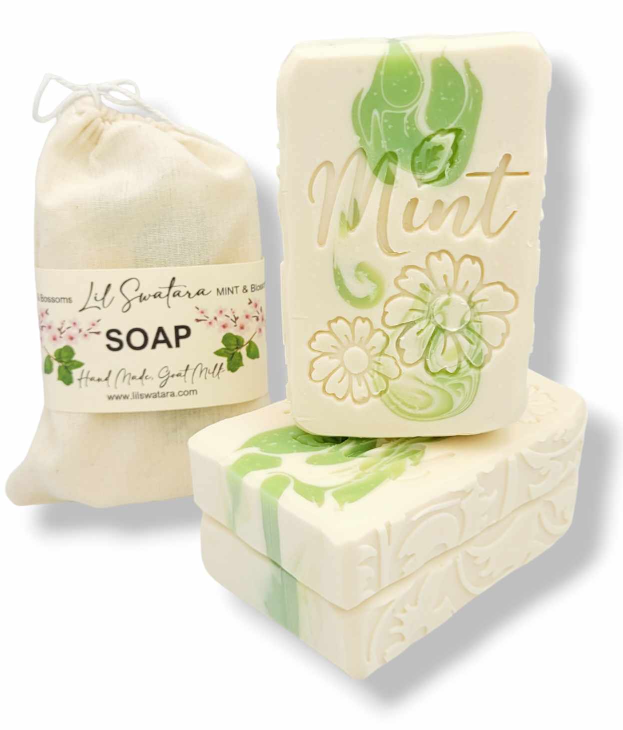 A set of handcrafted soap bars and a drawstring pouch from Lil Sweeta's. The soaps are cream-colored with light green and gold floral designs, including one bar embossed with the word 'Mint'.