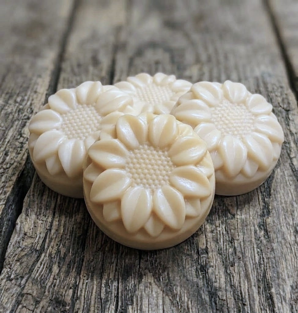Handcrafted goat milk tallow shampoo flower bar with detailed petals and creamy lather.