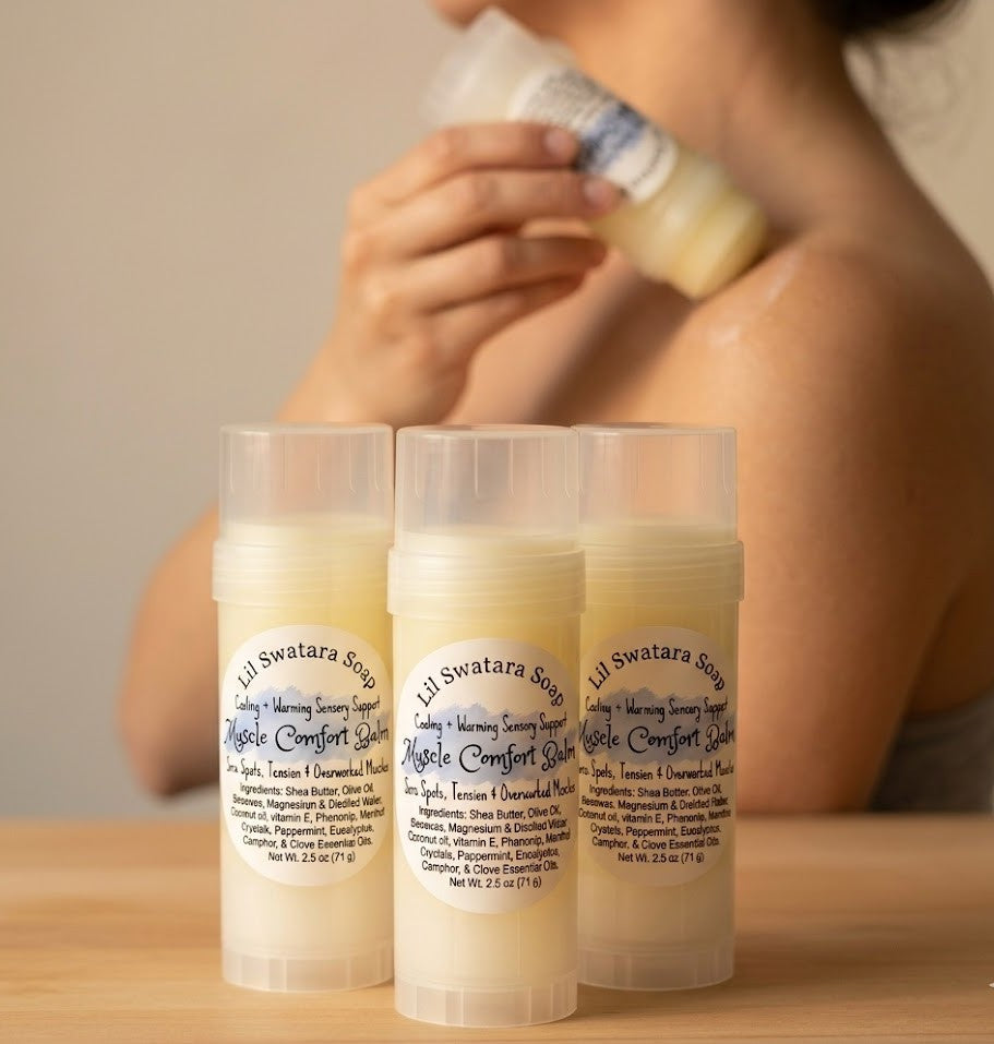 Muscle Comfort Balm displayed on a wooden table with a lady rubbing the balm stick to sooth muscle and get  relief.