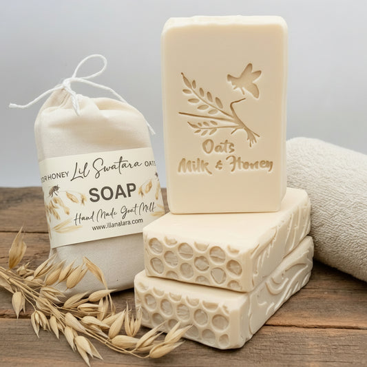 Creamy Oats Milk & Honey tallow goat milk soap bar with embossed text, stacked beside muslin soap pouch and dried oat sprigs on rustic wood.