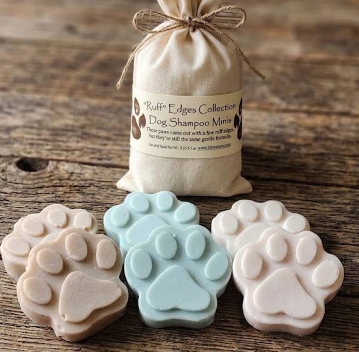 Paw‑shaped dog shampoo minis in a muslin soap sack from the Ruff Edges Collection.