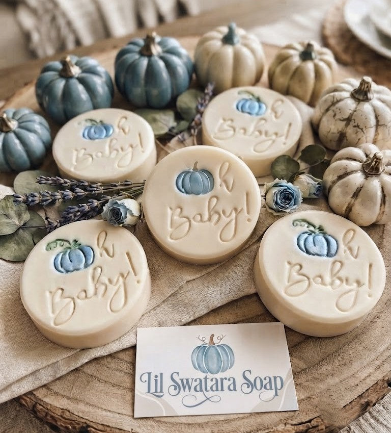 Oh Baby pumpkin baby shower soap stamp handmade soap bar Lil Swatara Round soap bars decorated with a small blue pumpkin and the words 'Oh Baby!' arranged on a rustic wood slice with decorative pumpkins, dried lavender, and flowers. A card at the bottom reads 'Lil Swatara Soap'.