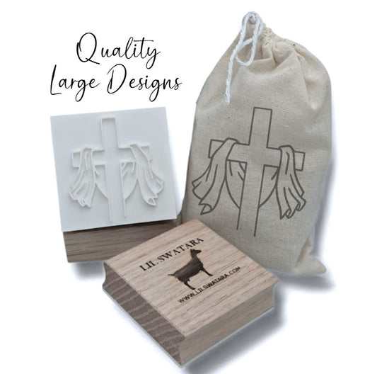Risen cross soap stamp with draped cloth design on red oak wood base, 57×52 mm.