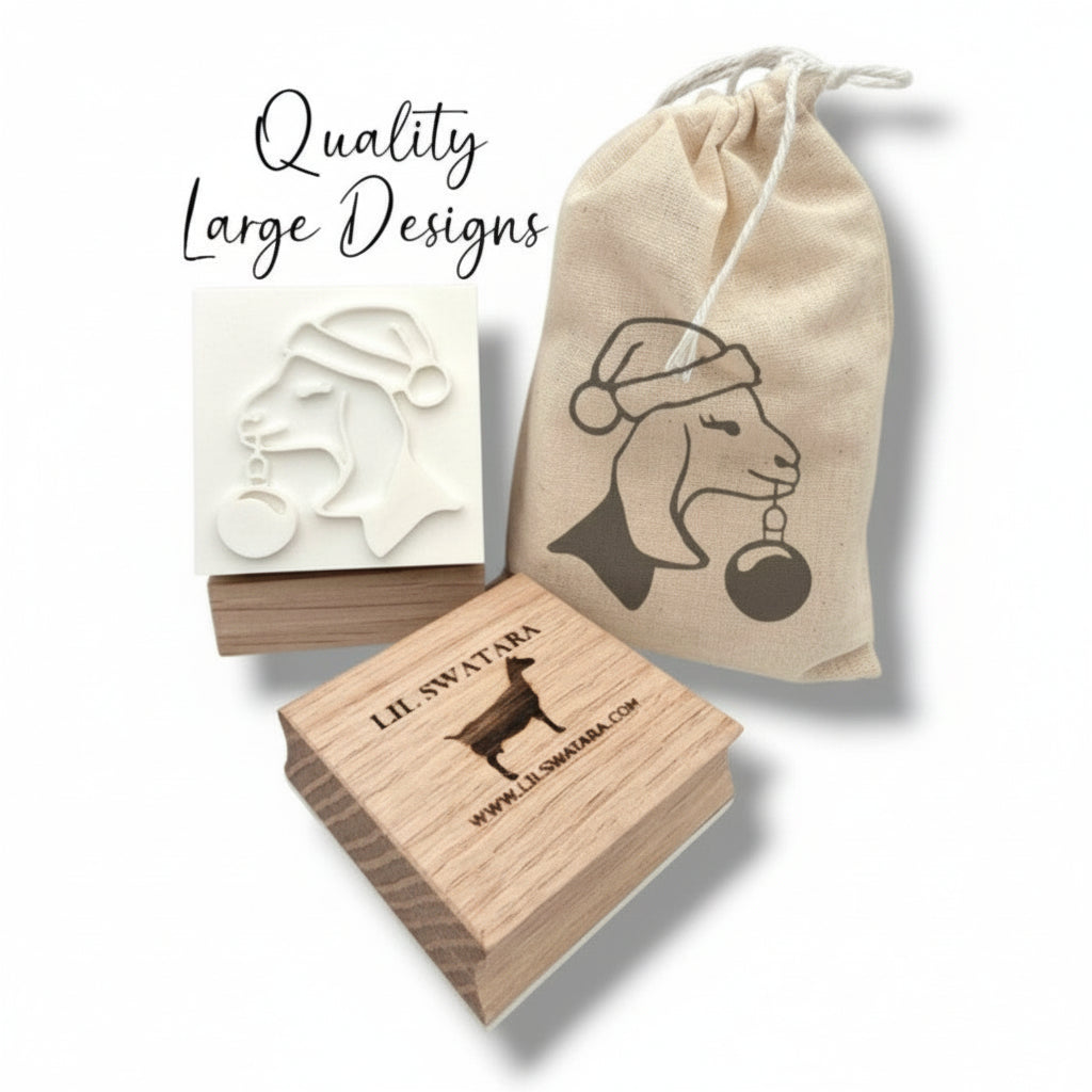 Wooden soap stamp with Nubian goat in Santa hat holding ornament, perfect for holiday-themed handmade soaps.