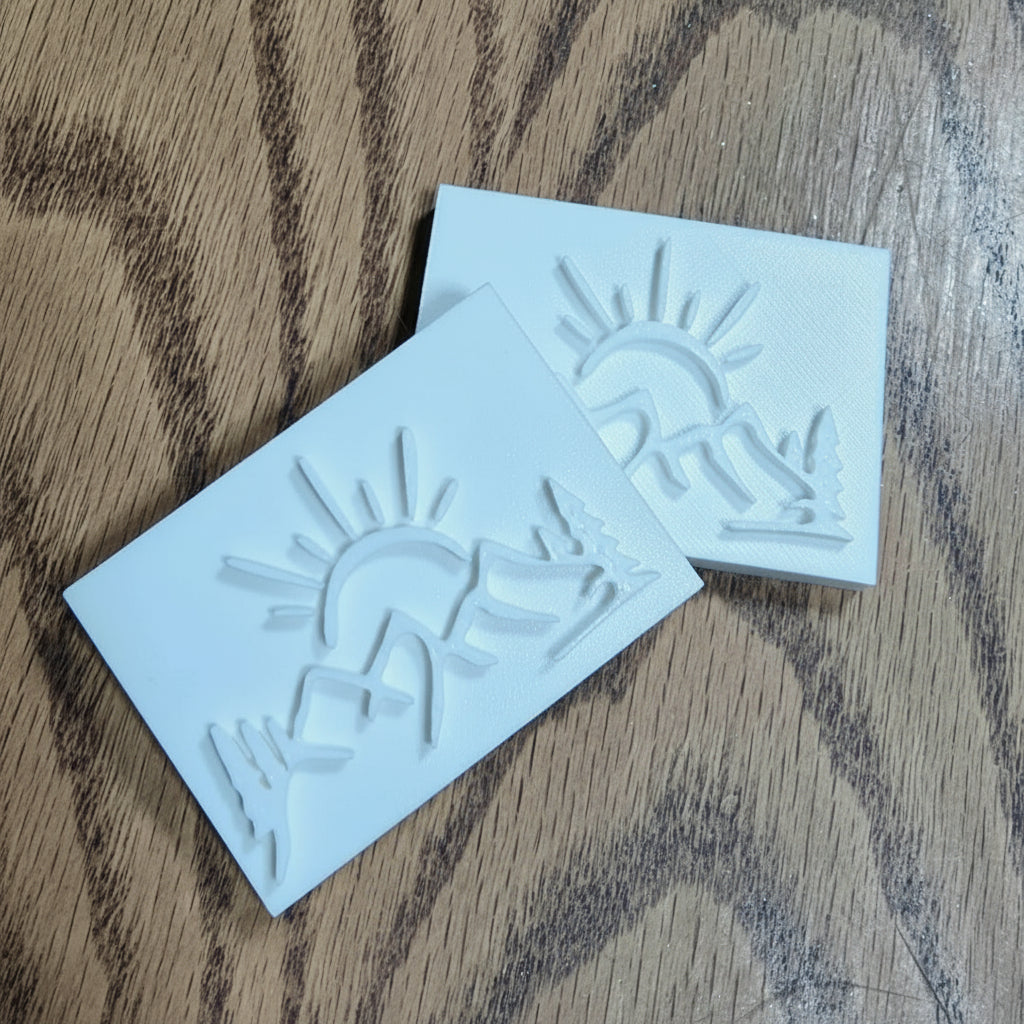 Mountain sun soap stamp with hand gesture of love and connection. 3D printed in high-quality PLA with a 60×40mm impression size.