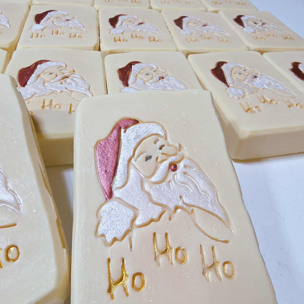 Wooden soap stamp with Santa Claus and “Ho Ho Ho” design, perfect for holiday-themed handmade soaps.