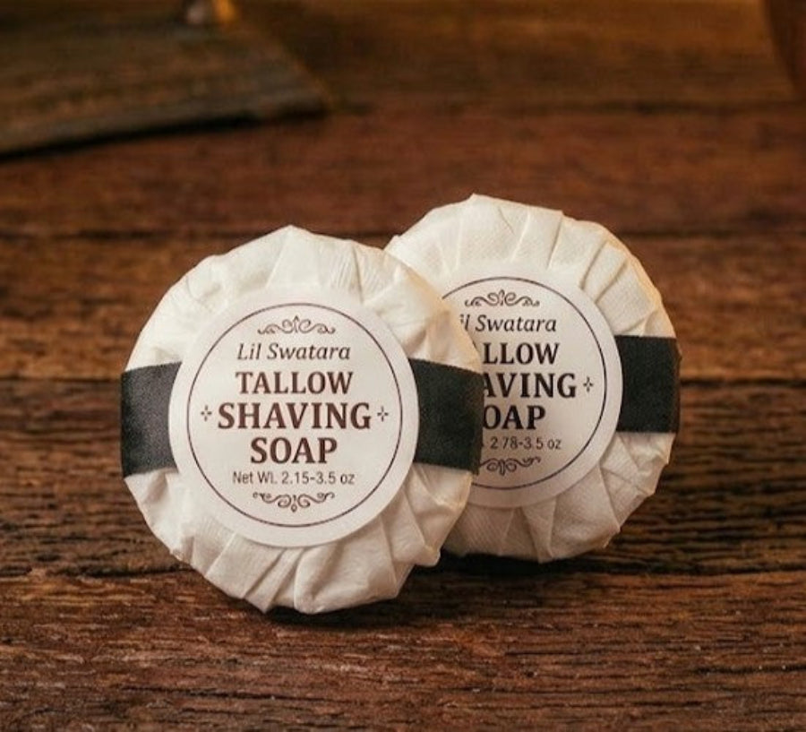 Two wrapped Lil Swatara tallow shaving soap discs on a rustic wood surface, labeled 2.15–3.5 oz.