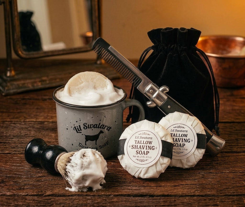 Lil Swatara tallow shave soap set with enamel shave mug, black-handled brush, straight razor, switchblade comb, and wrapped goat milk shave discs displayed on rustic wood.
