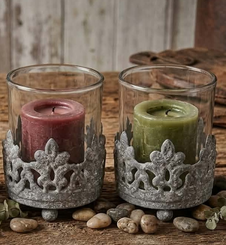 Vintage cast iron crown votive candle holder with clear glass insert on rustic wood table, candle not included.
